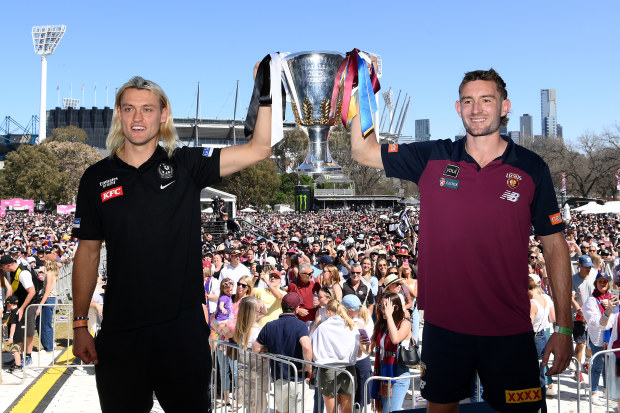 Darcy Moore of the Magpies and Harris Andrews of the Lions hold aloft the 2023 Premiership Cup.