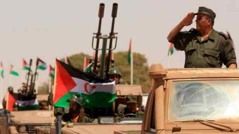 A Polisario Front soldier salutes during a military parade in Algeria, which suports the Sahrawi group fighting for independence for Western Sahara