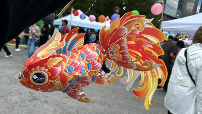 A paper lantern shaped like a goldfish.