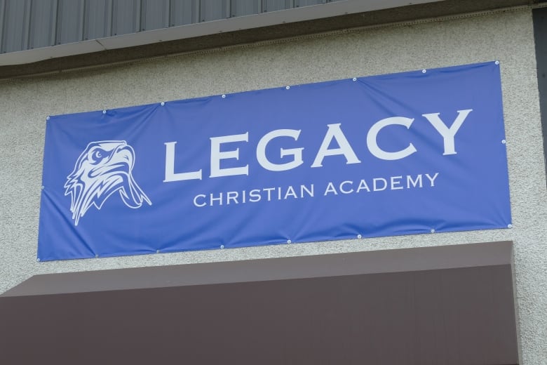 A blue sign that says "Legacy Christian Academy."