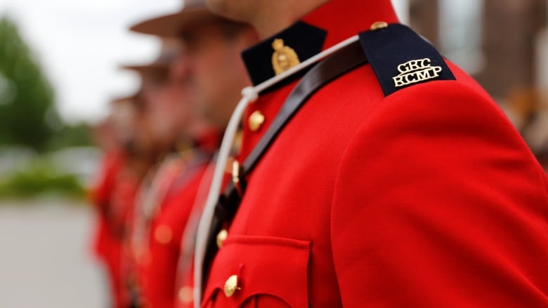 A line of Mounties in red serge.