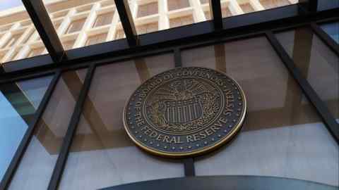 The seal of the Board of Governors of the Federal Reserve System is displayed on a window at the Federal Reserve building in Washington, DC.