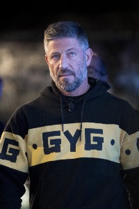 Steven Marks wearing a black and yellow GYG hoodie