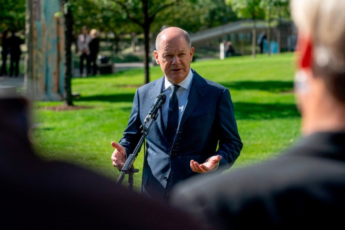 German Chancellor Olaf Scholz speaks to members of the German press in the grounds of the UN Headquarters building in New York on Monday