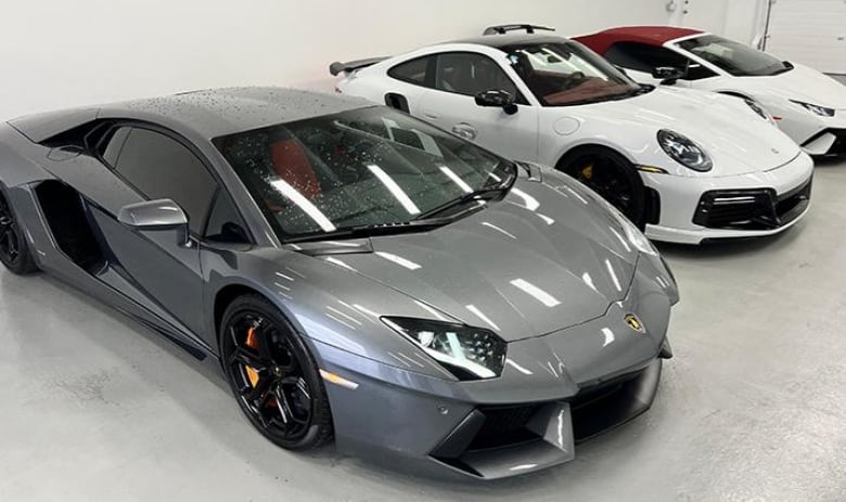 Very expensive cars lined up in a garage. 