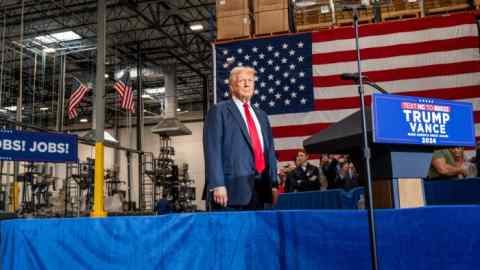 Republican presidential nominee, former U.S. President Donald Trump arrives to speak at a campaign rally at the Mosack Group warehouse in Mint Hill, North Carolina.