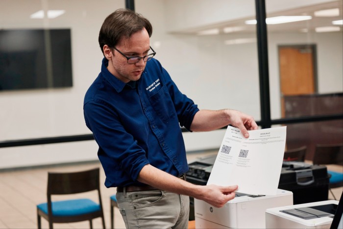 An election official carries out an elections security health check at the Dekalb County election headquarters 