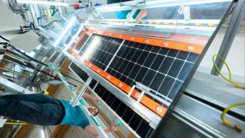 A solar panel under inspection at a factory