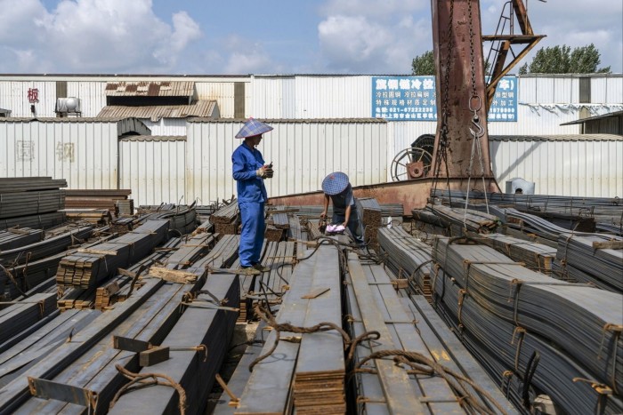 Workers at a steel trading market on the outskirts of Shanghai