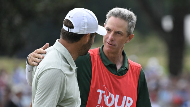 Scottie Scheffler of the United States hugs caddie Ted Scott after winning the TOUR Championship at East Lake Golf Club on September 01, 2024 in Atlanta, Georgia. (Photo by Ben Jared/PGA TOUR via Getty Images)