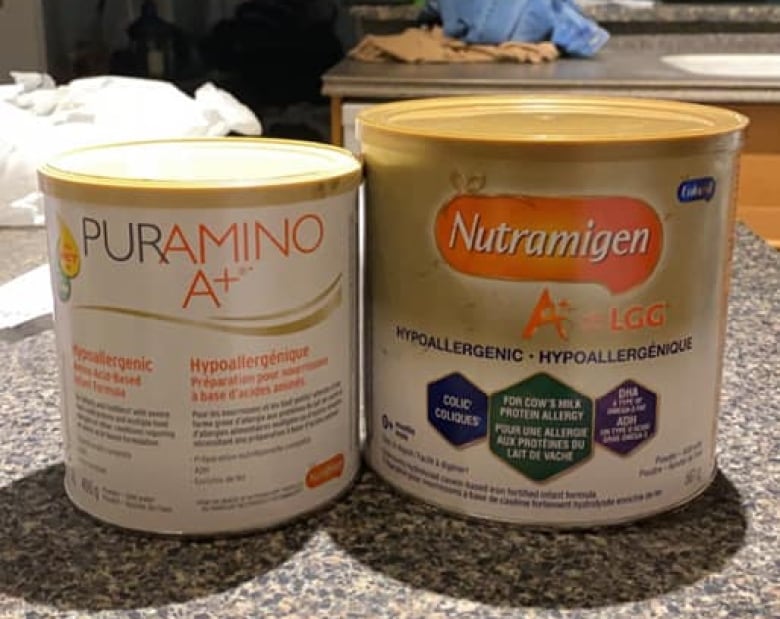 A photo of two brands of baby formula.