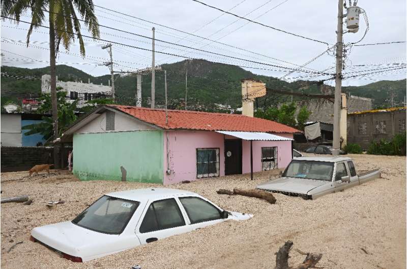 Cars were buried in feet of sand after Hurricane John struck Acapulco, Mexico