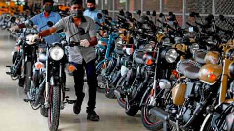 Workers park finished motorcycles at an assembly unit of Royal Enfield in Tamil Nadu