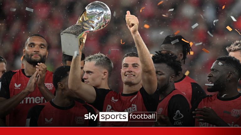 17 August 2024, North Rhine-Westphalia, Leverkusen: Soccer, DFL Supercup, Final, Bayer Leverkusen - VfB Stuttgart, BayArena: Leverkusen&#39;s Patrik Schick holds the trophy in the middle of the cheering team