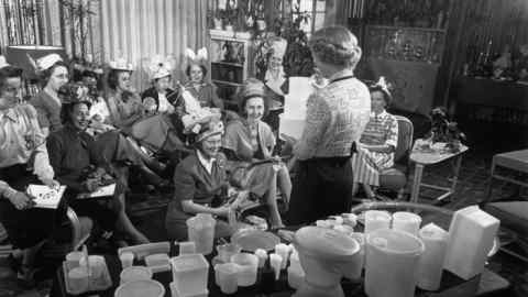 Women in a lounge room with plastic containers