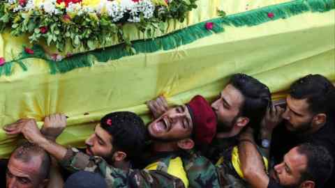 Men carry the coffin at the funeral of Mohammad Mahdi Ammar, son of Hizbollah member of the Lebanese parliament Ali Ammar