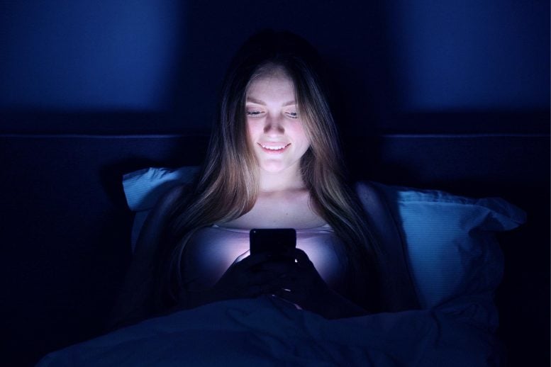 Young Woman Smartphone Bed