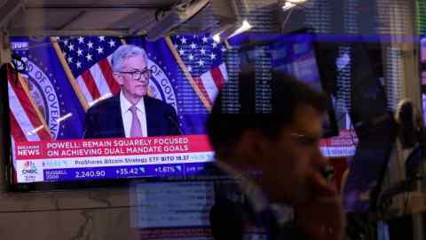 A screen on the trading floor at the New York Stock Exchange displays a news conference with Federal Reserve chair Jay Powell on September 18