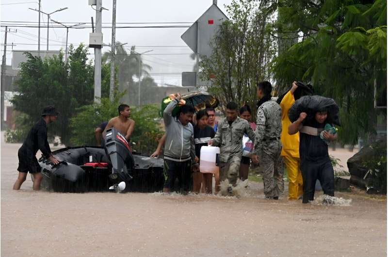 Mexican police and members of the National Guard help residents of Acapulco after Hurricane John caused major flooding