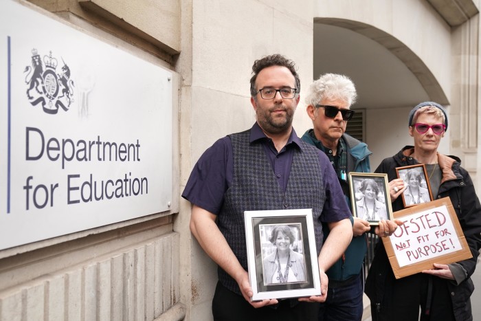 the three pople are holding framed portraits of Ruth Perry and a poster that reads: “Ofsted not fit for purpose!” 