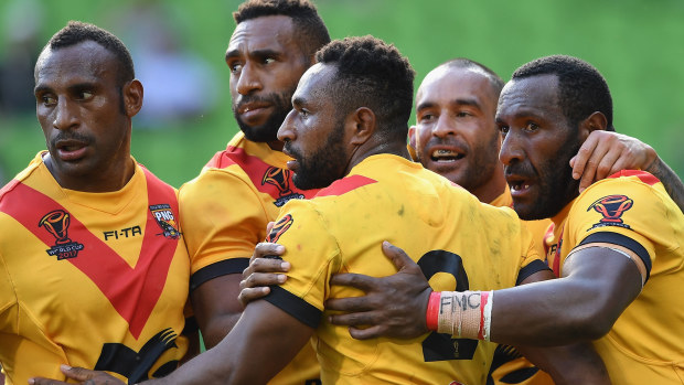 Papua New Guinea Kumuls players celebrate a try against England at the 2017 Rugby League World Cup quarter finals.