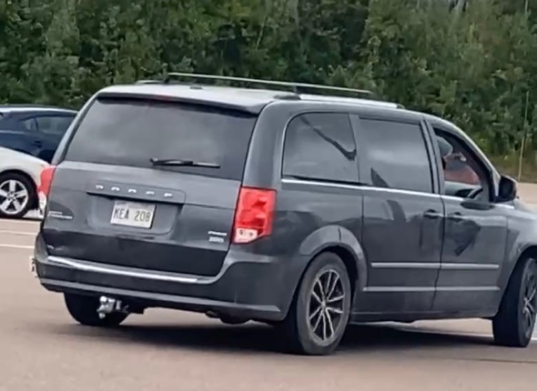 A black Dodge Caravan. 