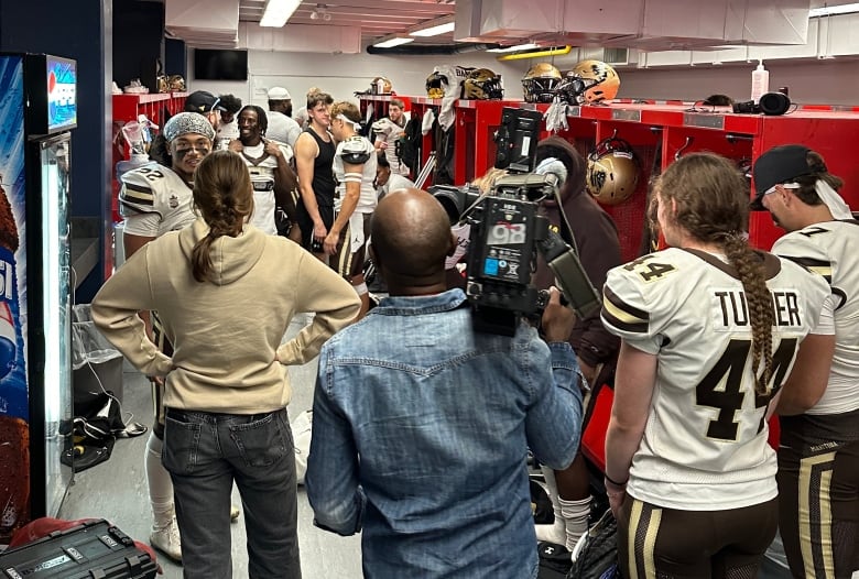 Amélie Beauregard meets the University of Manitoba Bison football players after their 22-17 victory over the University of Calgary Dinos on Sept. 21.