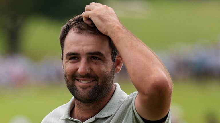 Scottie Scheffler celebrates winning on the 18th green the final round of the Tour Championship golf tournament, Sunday, Sept. 1, 2024, in Atlanta. (AP Photo/Mike Stewart)