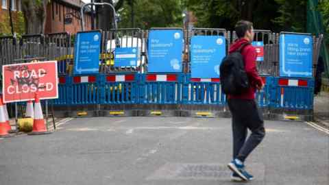 Public information signs from Thames Water on protective barriers surrounding water supply works in London