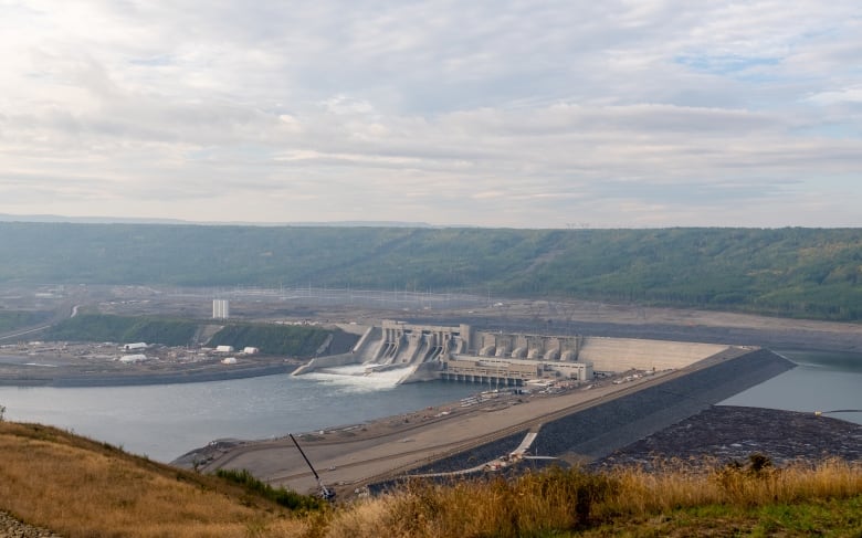 A large hydroelectric dam spans a wide river.