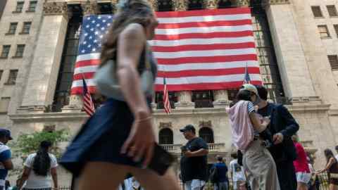 People walk past the New York Stock Exchange