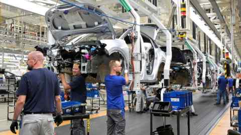 Volkswagen workers on the assembly line