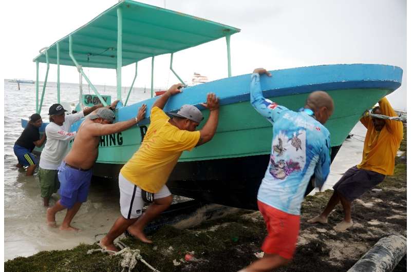 People secure their boats ahead of the arrival of Hurricane Helene in Cancun, Quintana Roo state, Mexico