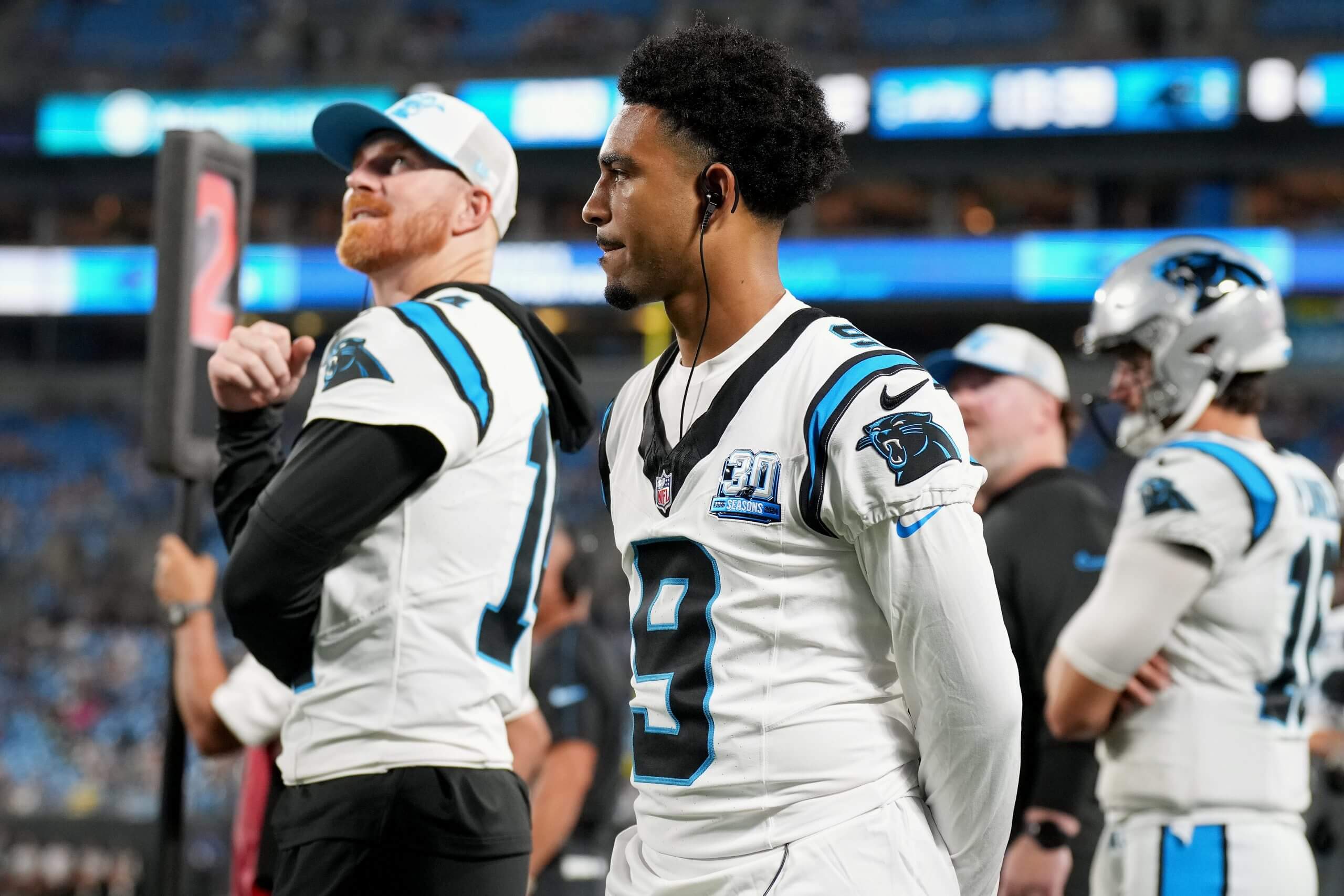 Andy Dalton and Bryce Young of the Carolina Panthers watch during the second half of their preseason game against the New York Jets at Bank of America Stadium on August 17, 2024 in Charlotte, North Carolina.