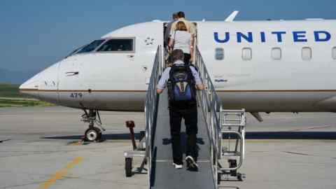 Passengers board a Bombardier CRJ200 jet, operated by United Airlines