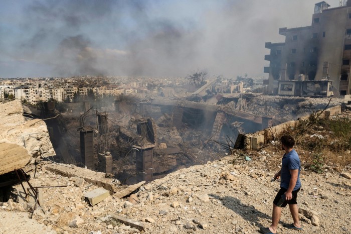 A man checks the destruction at a factory targeted in an overnight Israeli airstrike in the town of Chouaifet south of Beirut 