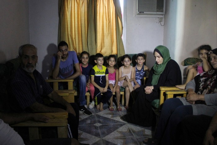 A Lebanese family of 20 sit in a shelter in the Syrian village of Sayyedah Zeinab, having fled across the border to escape the bombing