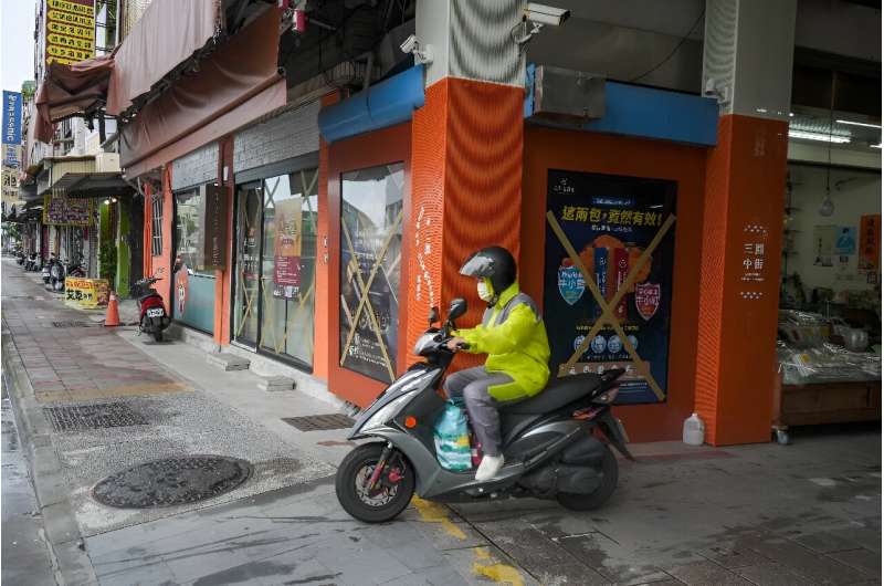 Residents of Kaohsiung prepared for the typhoon by taping windows and putting up flood barriers around their homes