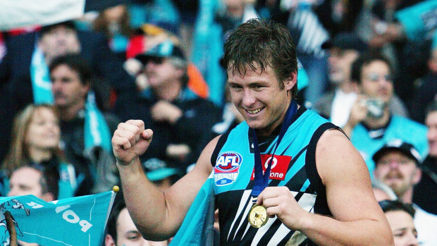 Stuart Dew celebrates Port Adelaide's 2004 premiership win over Brisbane at the MCG.