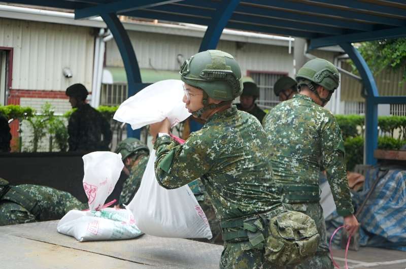 Taiwanese military personnel help fill sand bags as Typhoon Krathon approaches Kaohsiung island