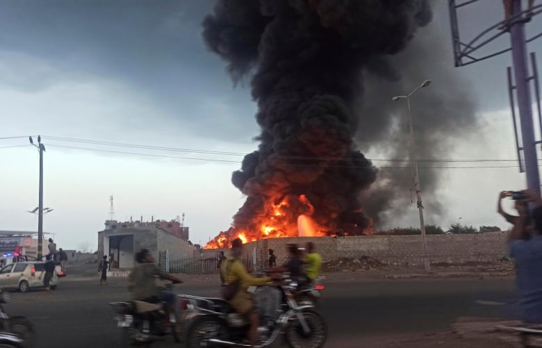 A large fire and plume of smoke is visible in the port city of Hodeida, Yemen, on Sunday, Sept. 29, 2024, after Israeli strikes on the Houthi-controlled city