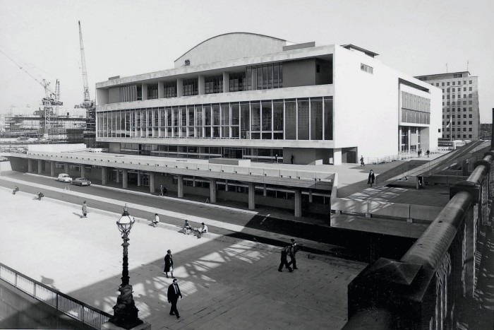 A black and white image of the same building. The street outside is less crowded, and empty of any other features