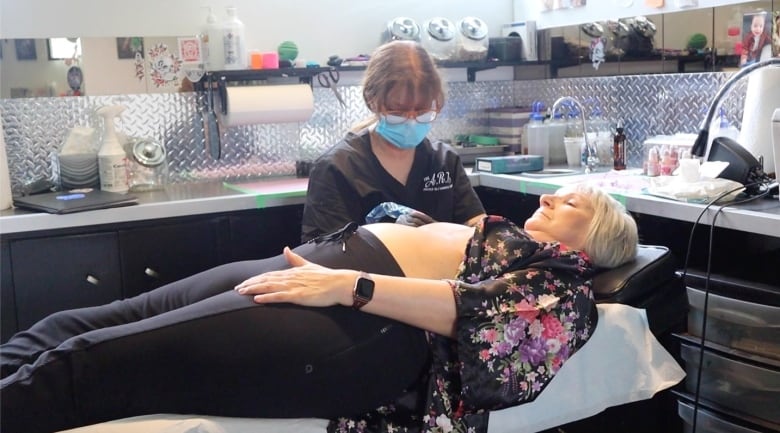 Cindy Kenway tattoos Starla Schneider at her shop in Qu'Appelle, Sask.