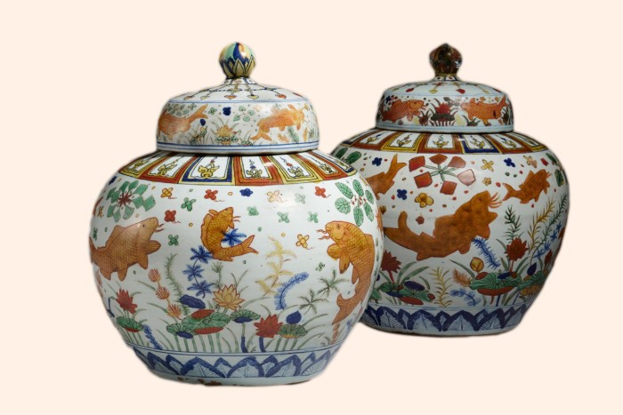 Two roundish porcelain jars with lids, lavishly decorated  with paintings of goldfish, carp, lotus and aquatic flora