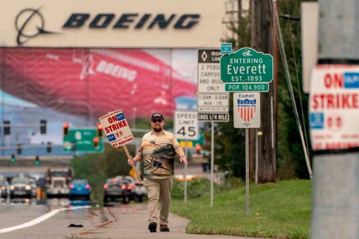 A Boeing worker walks to a picket site 