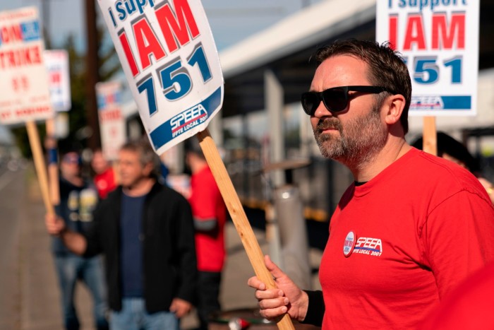 SPEEA officer Ryan Rule pickets in support of IAM District 751 outside of a Boeing facility near Boeing Field during an ongoing strike in Seattle, Washington 