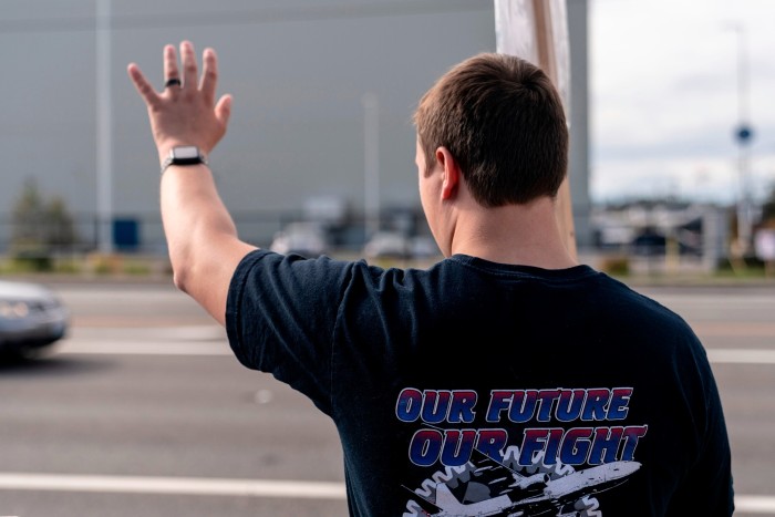 A Boeing worker pickets outside of the Boeing Everett factory during an ongoing strike in Everett, Washington