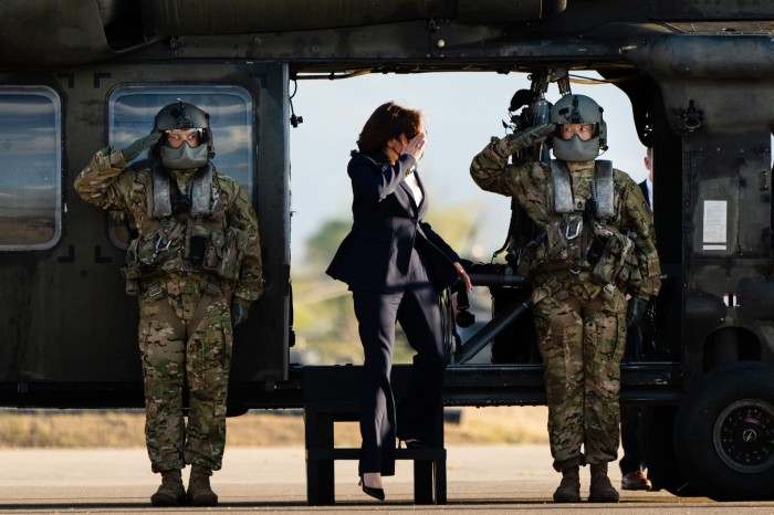 Harris walks on to an airfield to to begin her journey back from Honduras to Washington in 2022