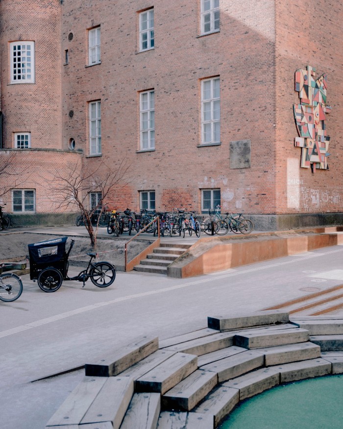 Detail of the red-brick facade of Carlsberg’s Machine Central, with steps leading down to a water feature