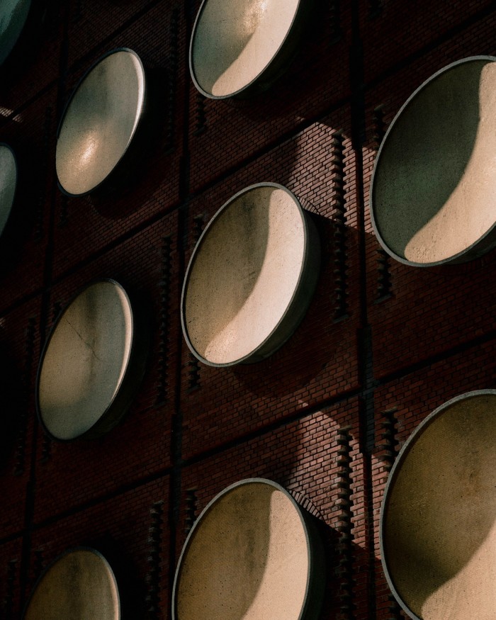 A few of the 64 gold-leaf-covered discs on the facade of the Hotel Ottilia 